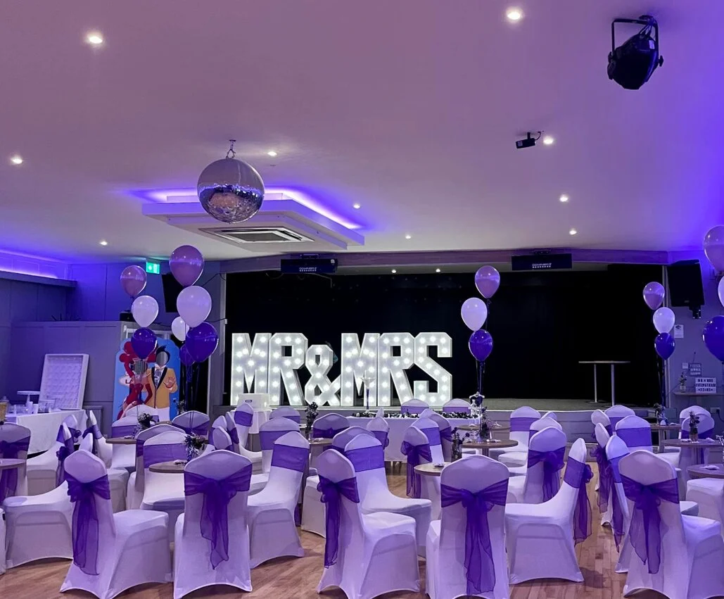 Large function room laid out for a wedding reception with tables and a dance floor