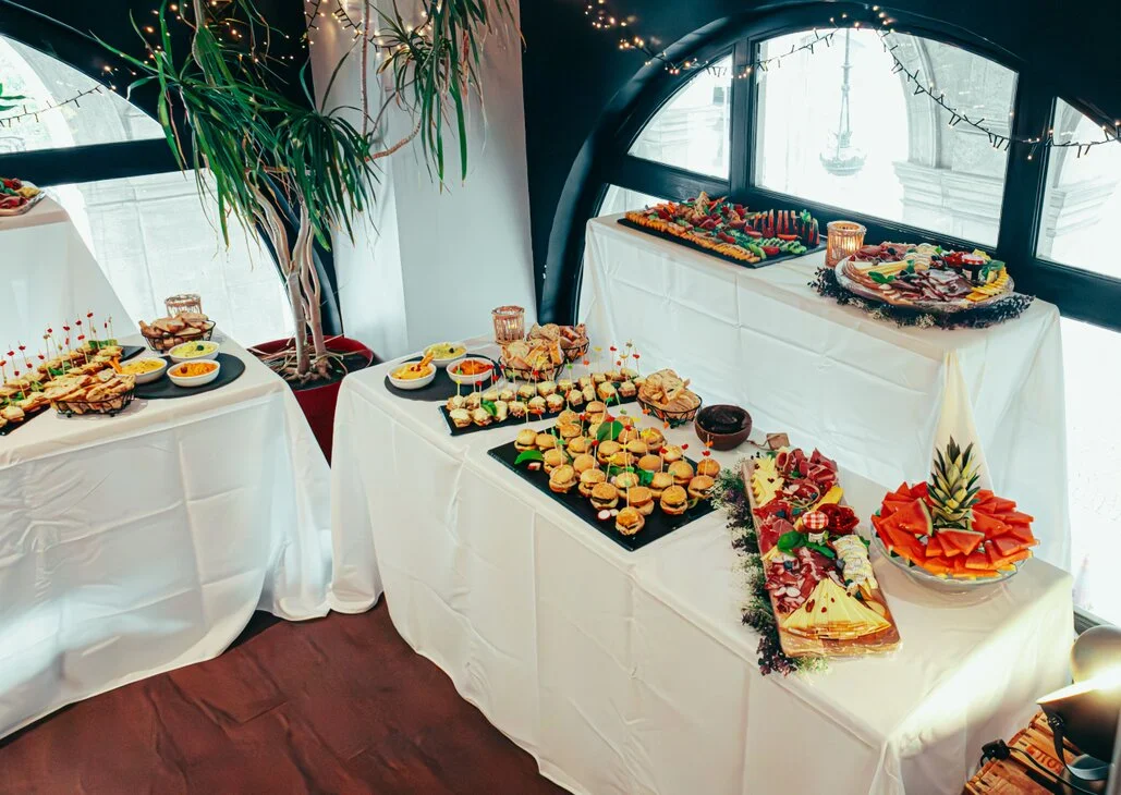 Buffet table laid out with party food and guests helping themselves
